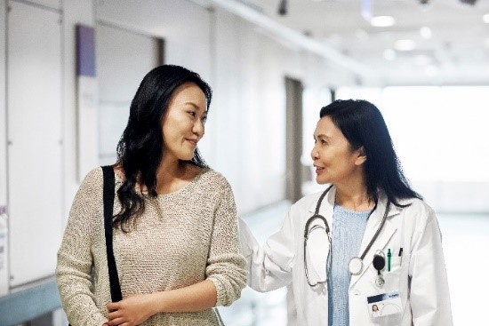 Doctor and patient walking in hallway