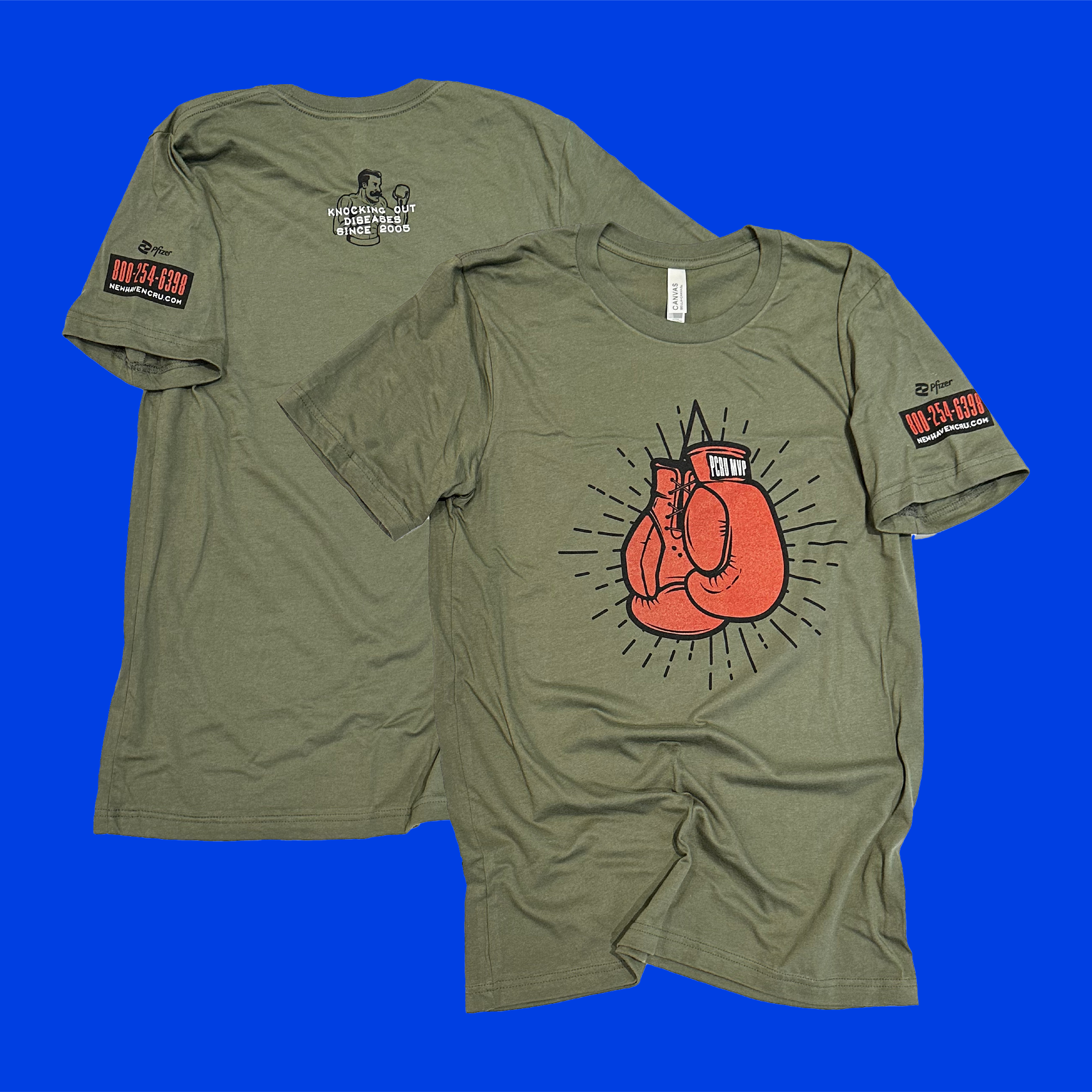 A medium green t-shirt on a bold blue background with an image of boxing gloves that say "PCRU MVP" printed on the front and writing on the back and sleeve.