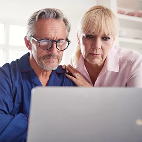 Portrait of couple looking at computer – Pfizer Clinical Trials