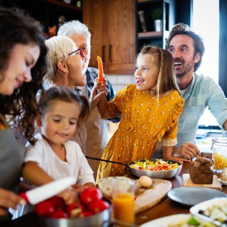 A happy family around the kitchen | Pfizer clinical trials