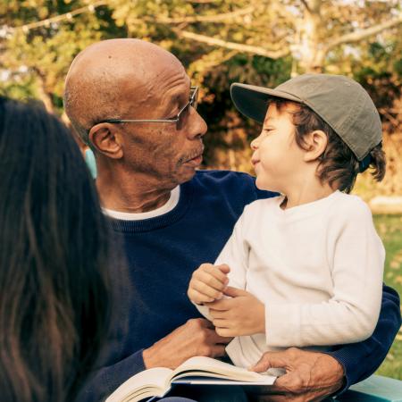 Man holding grandchild in park – Pfizer Clinical Trials