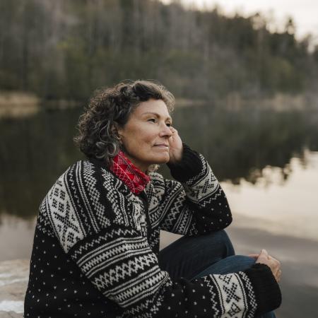 Women content, smiling overlooking an ocean – Pfizer Clinical Trials