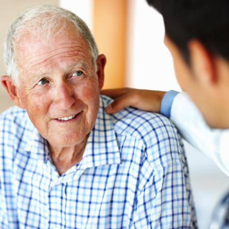 Man consulting doctor in clinic | Pfizer clinical trials