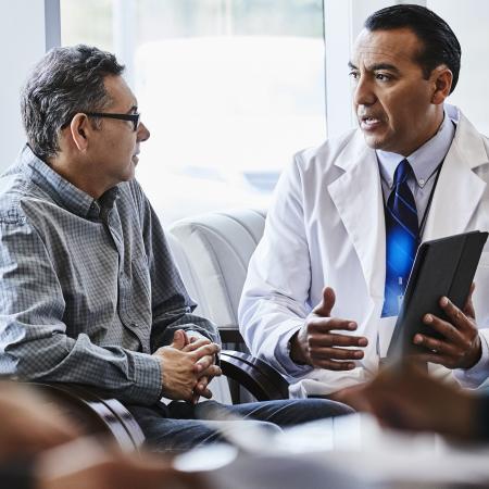 Doctor consulting patient in clinic | Pfizer clinical trials
