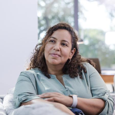 Portrait of a woman on couch – Pfizer Clinical Trials