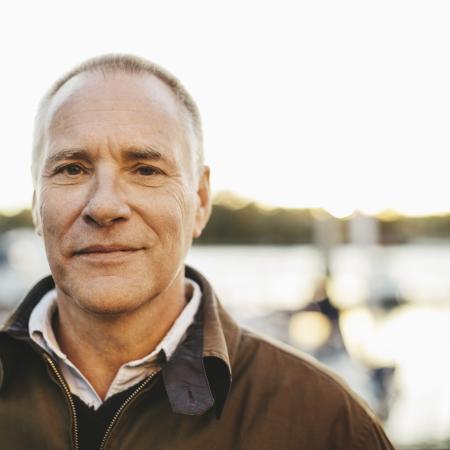 Portrait of a man standing outside looking forward – Pfizer Clinical Trials