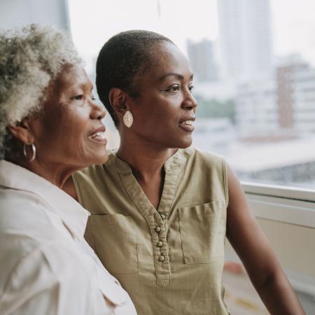 Mother and daughter looking at view from doctor’s office – Pfizer Clinical Trials
