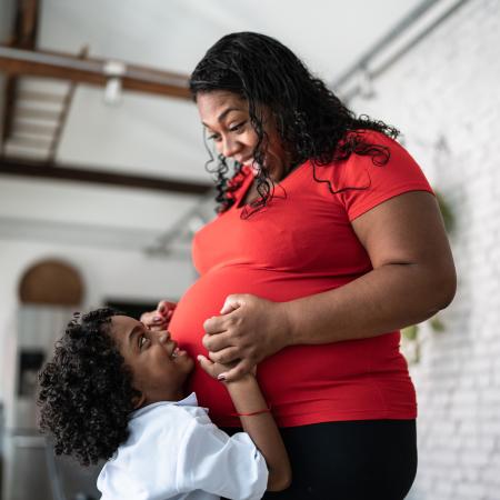 Pregnant mother with her young son touching her stomach    – Pfizer Clinical Trials