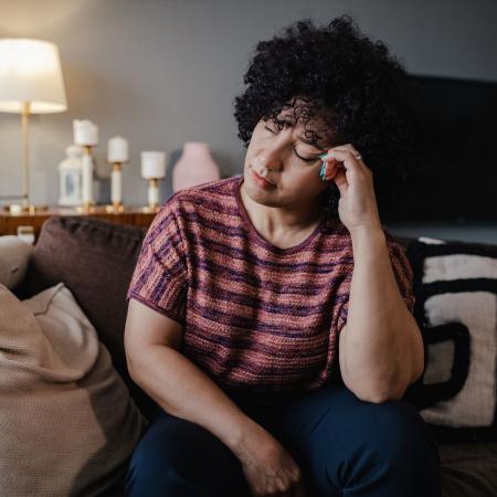 Portrait of a woman inside with migraine – Pfizer Clinical Trials