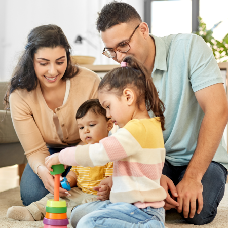 Multicultural family in living room | Pfizer clinical trials